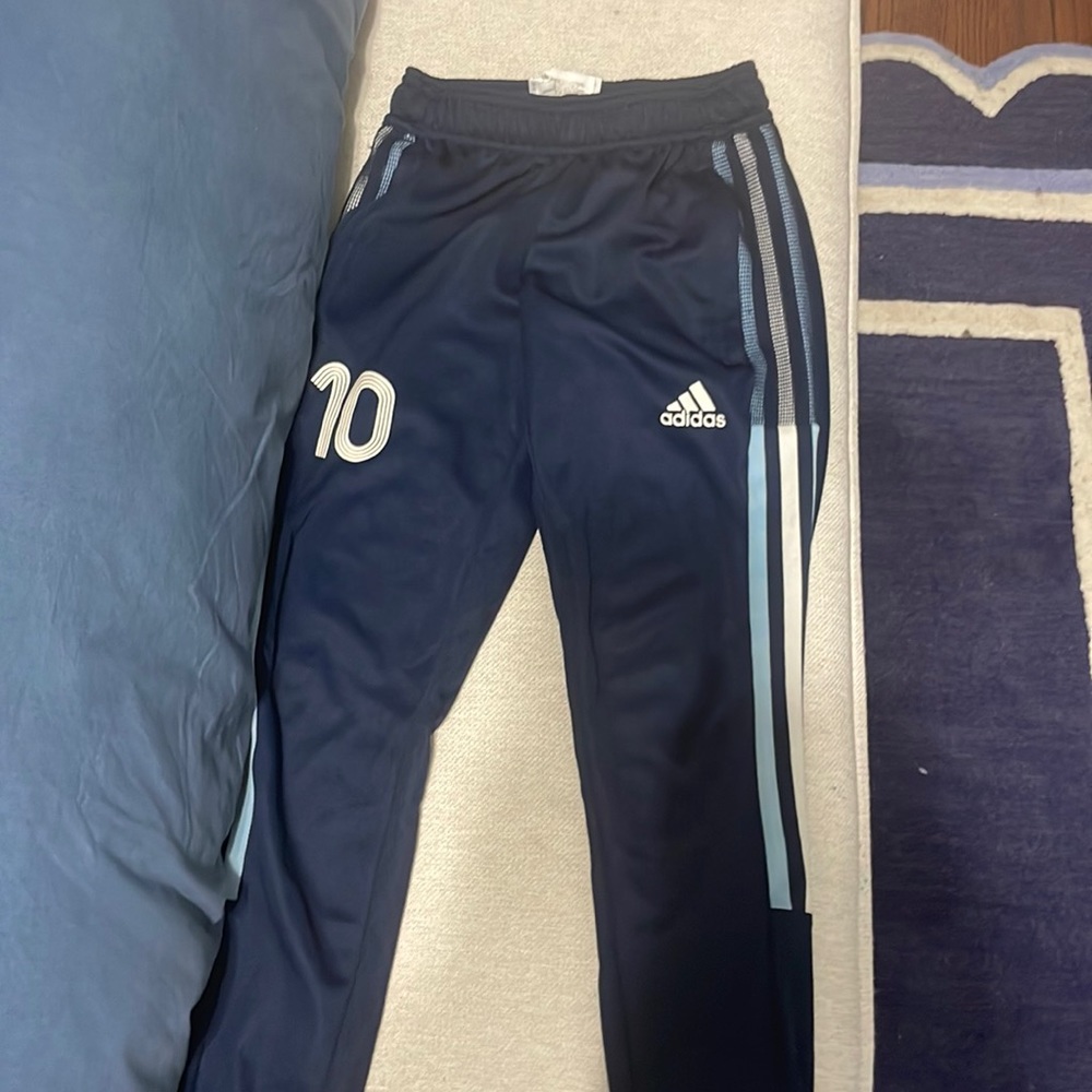 Adidas messi boys soccer pants and a pair of adidas shorts.